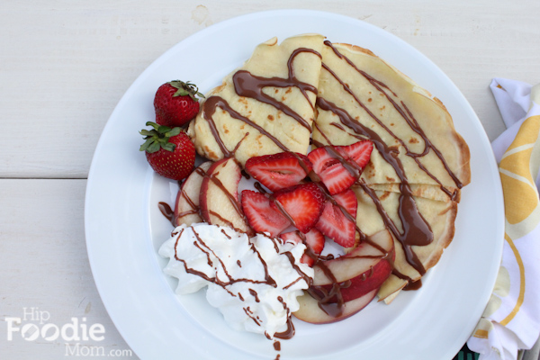 Crepes with fresh strawberries, peaches and nutella