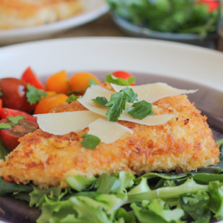 Spicy Chicken Milanese. Breaded and pan-fried chicken cutlets topped with a juicy tomato salad and salty slivers of Parmesan cheese.