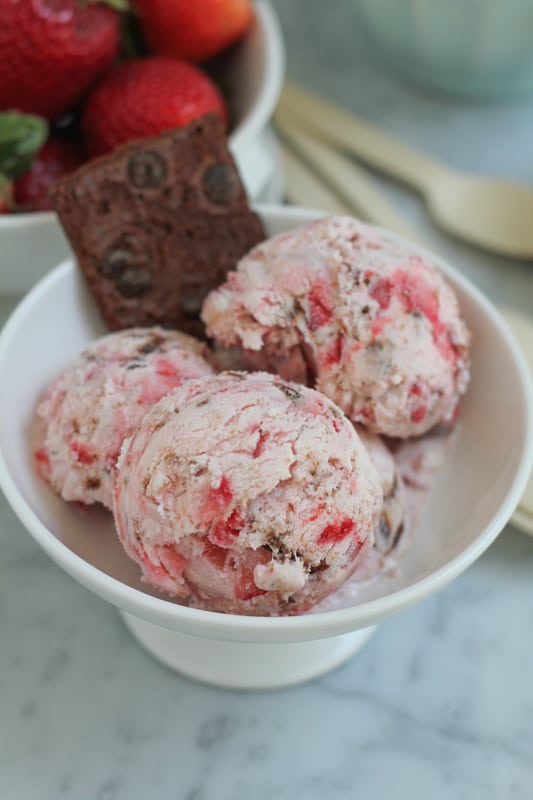 Scoops of Strawberry Cheesecake Brownie Brittle Ice Cream in a bowl.