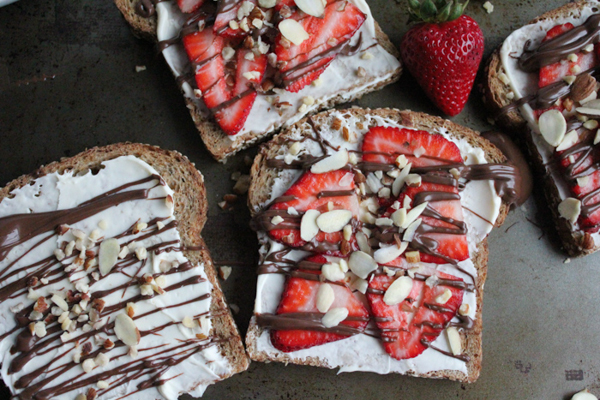 The Best Toast You'll Ever Have!! Toasted bread smothered with honey mascarpone & topped with fresh strawberries, melted Nutella and sliced almonds and hazelnuts. 