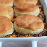 Mexican Biscuit Casserole! Change up taco night!! Seasoned ground beef with black beans and beef, topped with big flaky buttermilk biscuits!