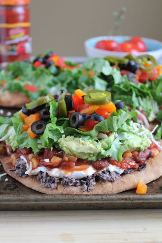 7 Layer Dip Flatbread on a metal baking tray.