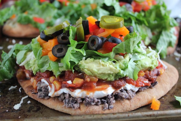 7 Layer Dip Flatbreads on baking tray.