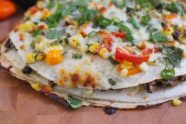 Corn and Black Bean Tortilla Tart on a wood cutting board.