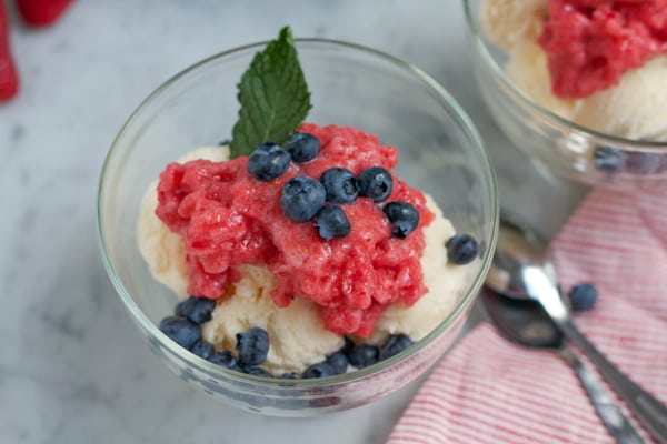 Red White and Blue Granita Dessert in a glass garnished with mint.