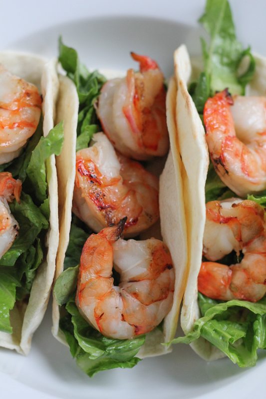 Grilled Shrimp Tacos with Mexican Crema on a white plate.