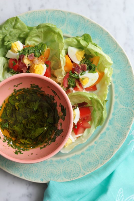 Cobb Salad Lettuce Wraps on a plate with a bowl of chimichurri sauce.