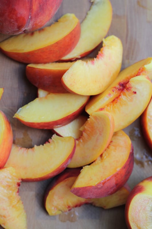 Sliced peaches for Olive Oil Honey Cake With Fresh Peaches.
