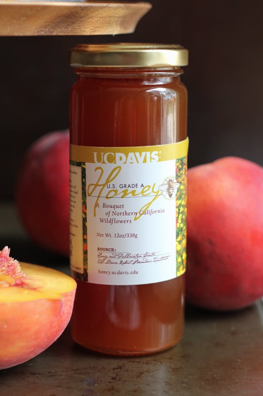 Jar of honey for Olive Oil Honey Cake With Fresh Peaches.