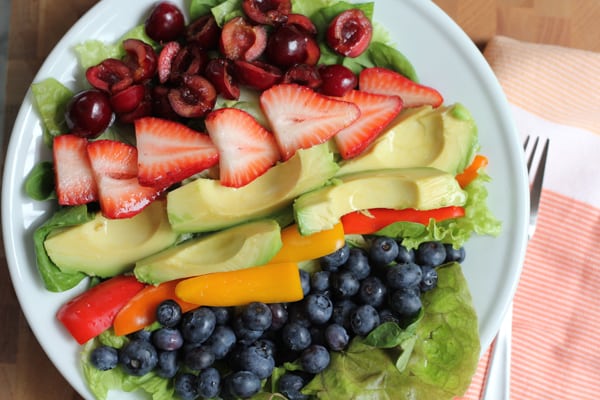 Summer Berry Salad on a plate with a napkin and fork.