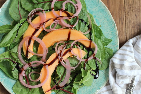 A plate of Simple Cantaloupe Salad with balsamic glaze.