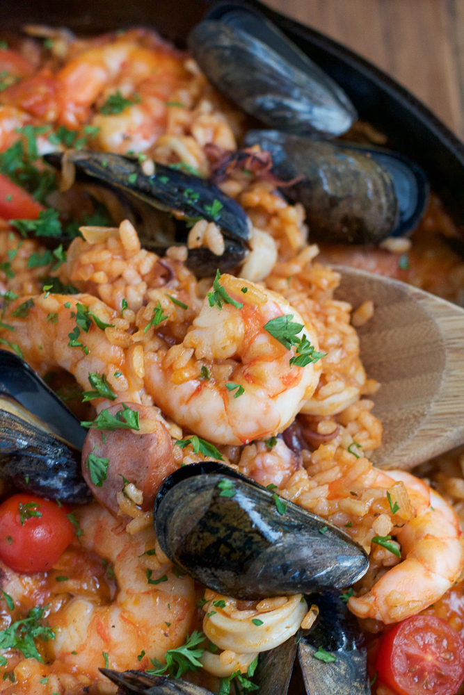 seafood dinner with shrimp, mussels, tomatoes and rice