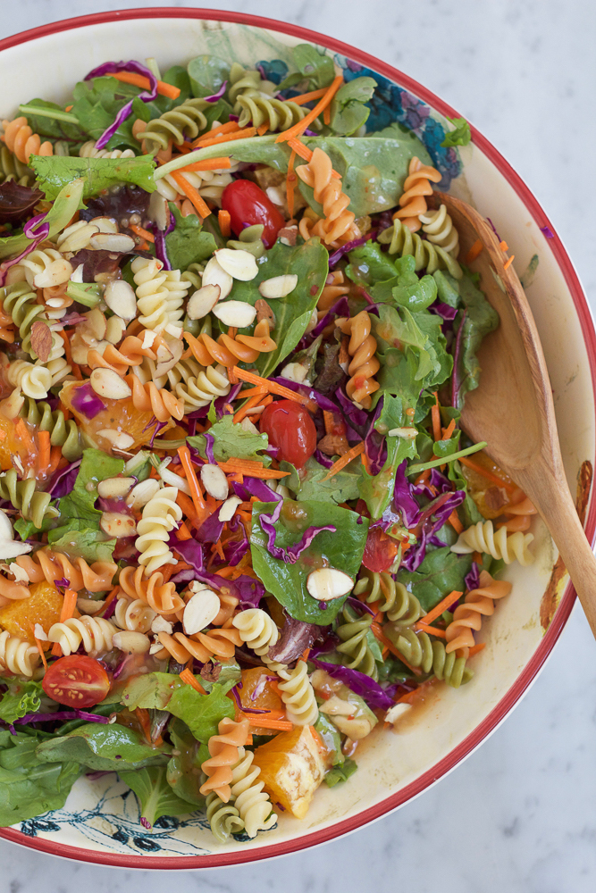 Power Pasta Salad in a bowl with a wooden spoon.