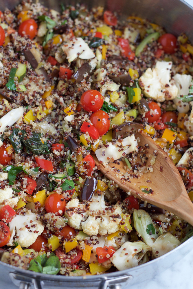 A pot of Summer Quinoa Salad with a wooden spoon.