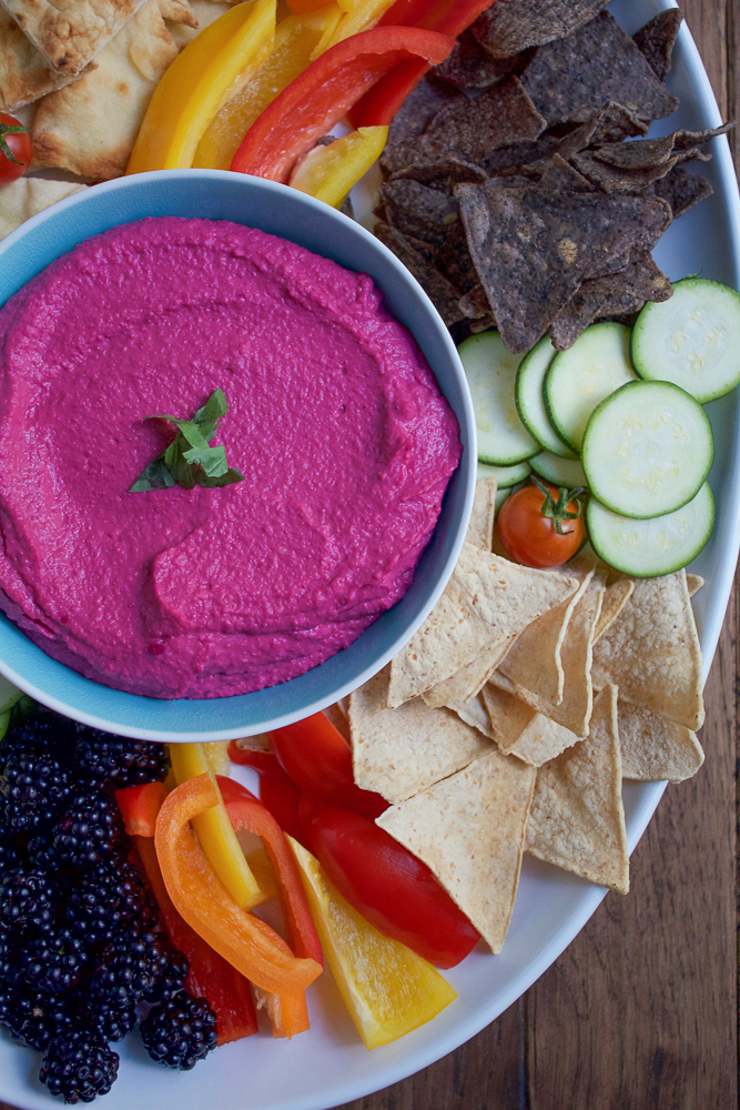 Roasted Beet Hummus. Try this delicious, vibrant twist on one of your favorite foods to snack on! Serve this beet hummus with raw veggies, chips and pita bread. This makes for a great party or appetizer platter.