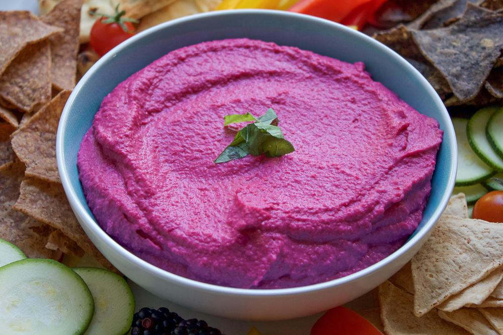 Roasted Beet Hummus. Try this delicious, vibrant twist on one of your favorite foods to snack on! Serve this beet hummus with raw veggies, chips and pita bread. This makes for a great party or appetizer platter.