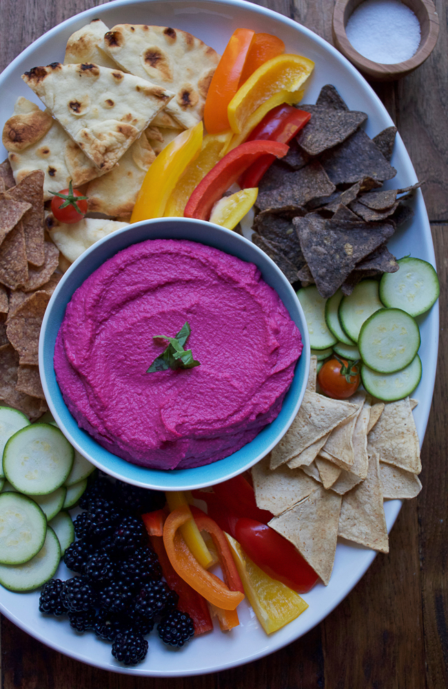 Roasted Beet Hummus. Try this delicious, vibrant twist on one of your favorite foods to snack on! Serve this beet hummus with raw veggies, chips and pita bread. This makes for a great party or appetizer platter.