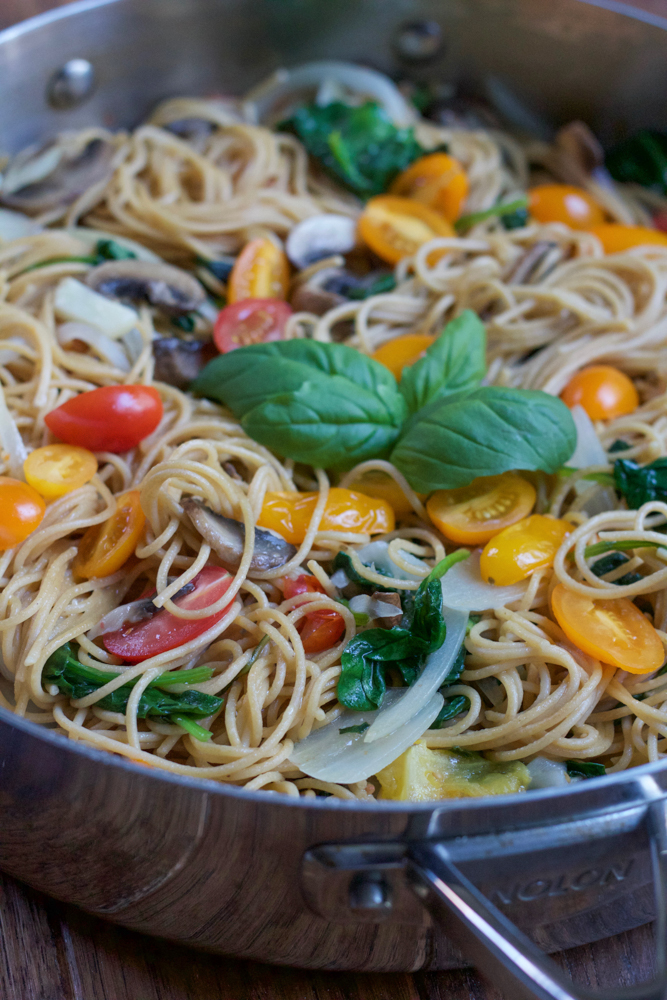 One Pot Pasta topped with fresh basil in a pot.