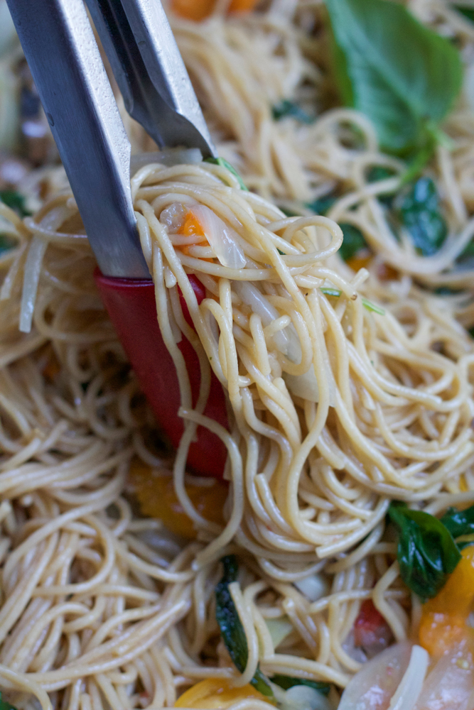 One Pot Pasta being served with tongs.
