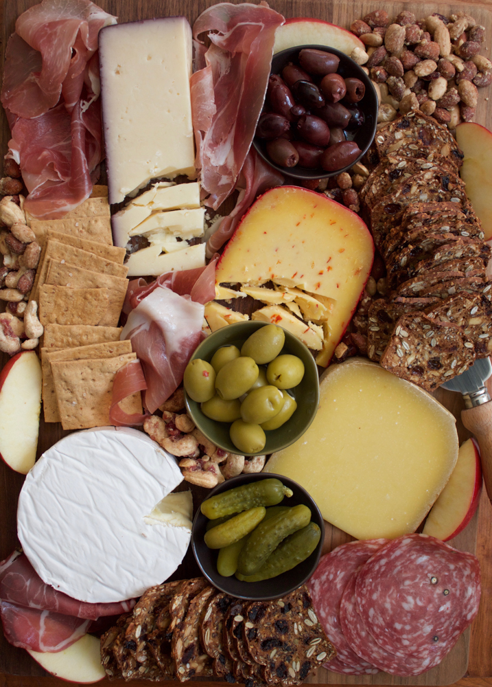 How To Make A Charcuterie Board + A Video! I'm sharing tips on how to assemble the best charcuterie board! Packed with meats, cheese, pickles, nuts, crackers and more, this is the easiest and most delicious platter to put together for your guests for the holidays! There's sure to be something there for everyone! 