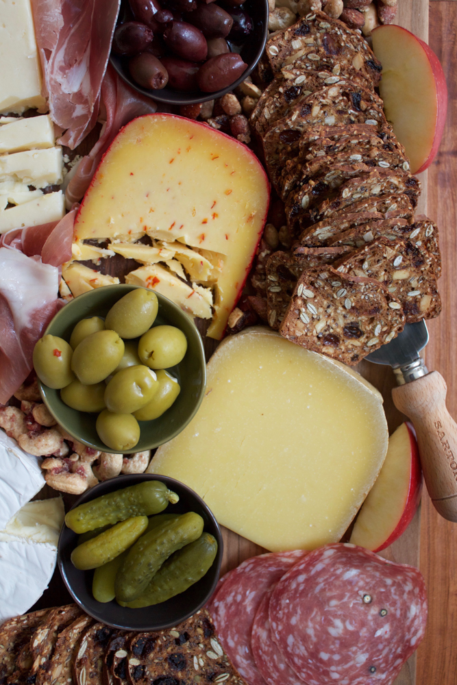 How To Make A Charcuterie Board + A Video! I'm sharing tips on how to assemble the best charcuterie board! Packed with meats, cheese, pickles, nuts, crackers and more, this is the easiest and most delicious platter to put together for your guests for the holidays! There's sure to be something there for everyone! 