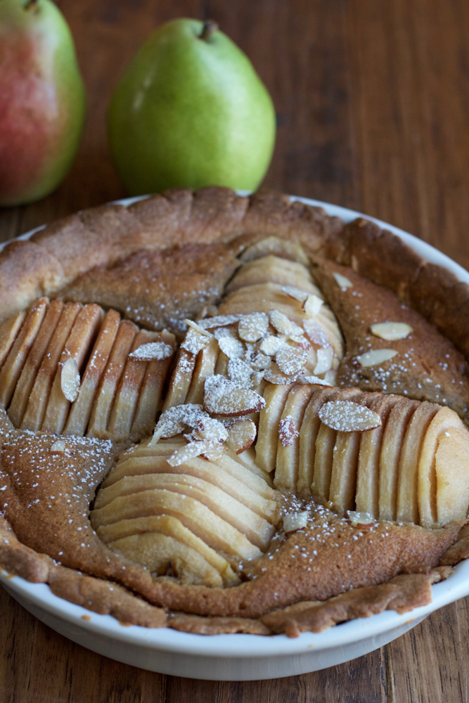 Pear Almond Tart made with poached pears, a tender, flavorful all-butter crust and a delicious almond filling. Not too sweet and amazing flavor! This is the most delicious tart ever! 