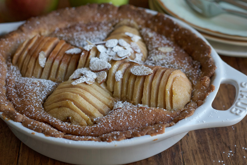 Pear Almond Tart made with poached pears, a tender, flavorful all-butter crust and a delicious almond filling. Not too sweet and amazing flavor! This is the most delicious tart ever! 
