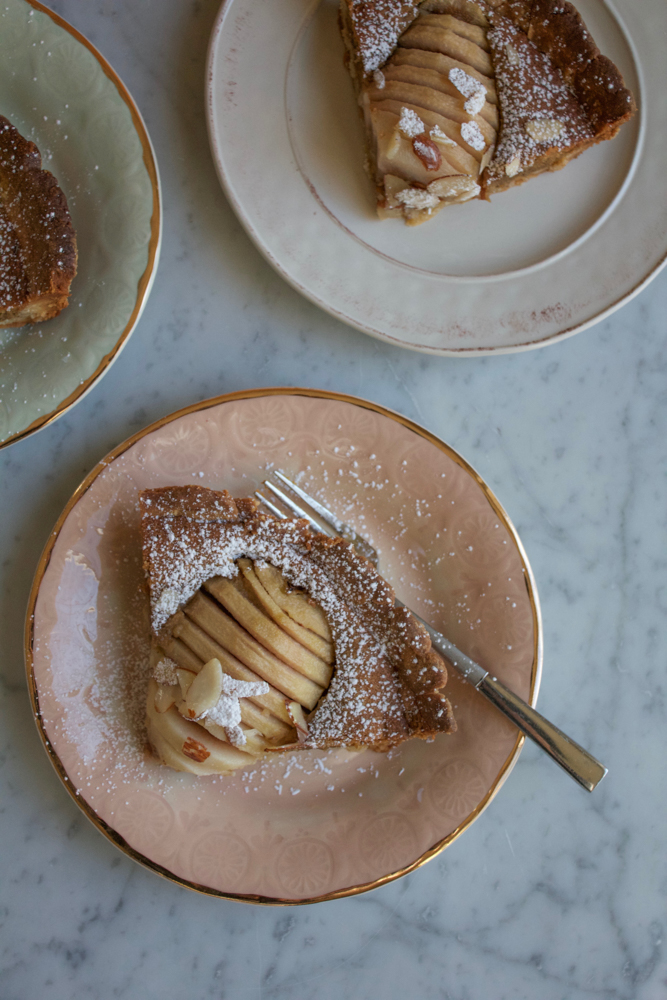 Pear Almond Tart made with poached pears, a tender, flavorful all-butter crust and a delicious almond filling. Not too sweet and amazing flavor! This is the most delicious tart ever! 