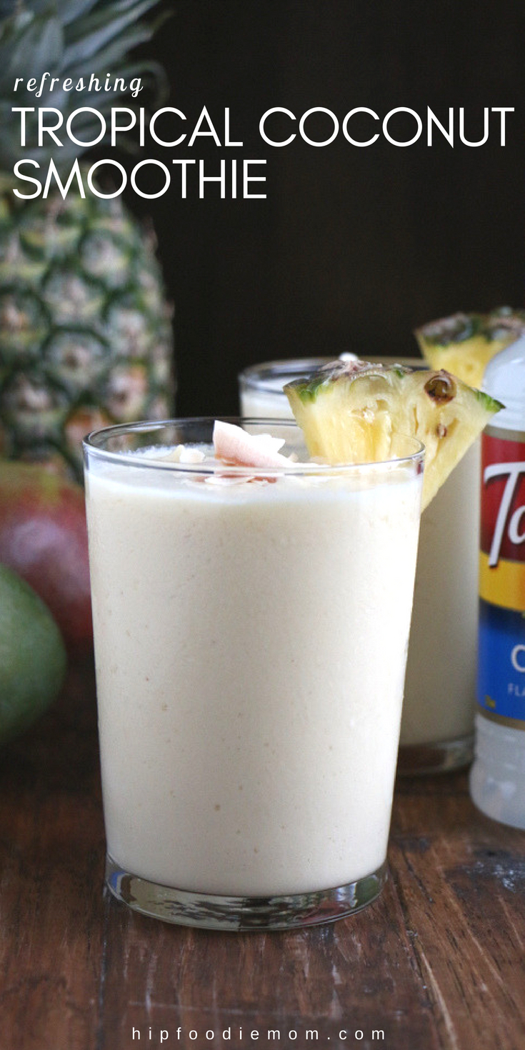Refreshing Tropical Coconut Smoothie made with Torani Coconut Syrup, frozen mangos, pineapples and more! Let this smoothie transport you! #tropicalsmoothie #coconutsmoothie #smoothierecipe #mangosmoothie #pineapplesmoothie #breakfastsmoothie #coconut