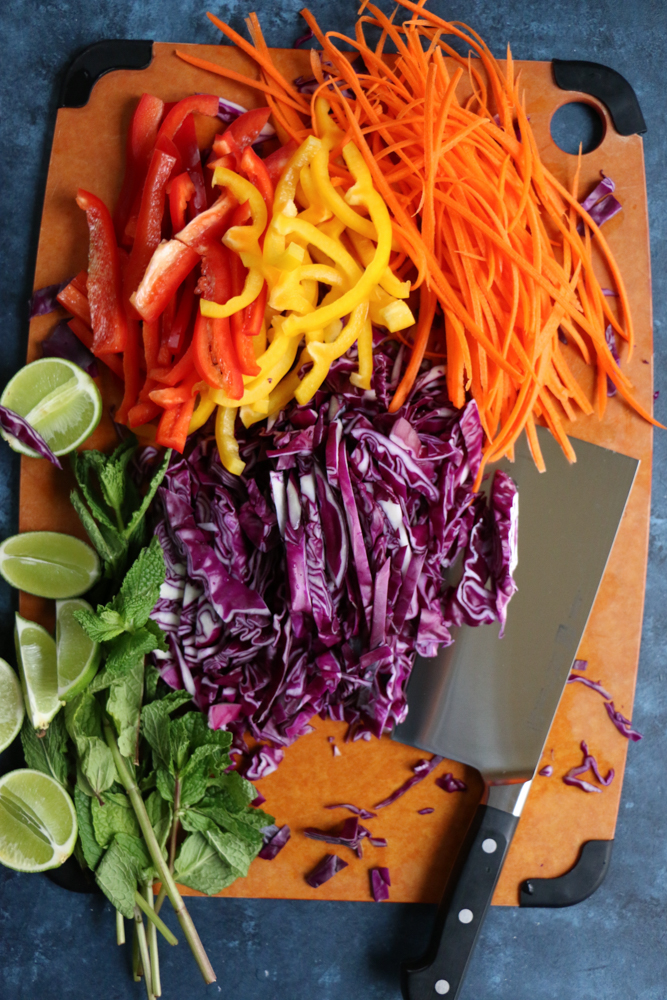 A board of chopped veggies for Chicken and Veggie Spring Rolls.