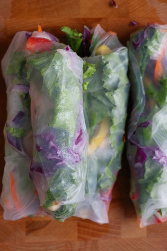 Wrapped Chicken and Veggie Spring Rolls on a board.
