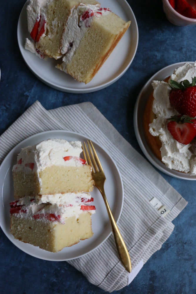 Strawberry Layer Cake with fresh homemade whipped cream and strawberries! Fresh, light and delicious! This is sure to be a show stopper at any party or special gathering!