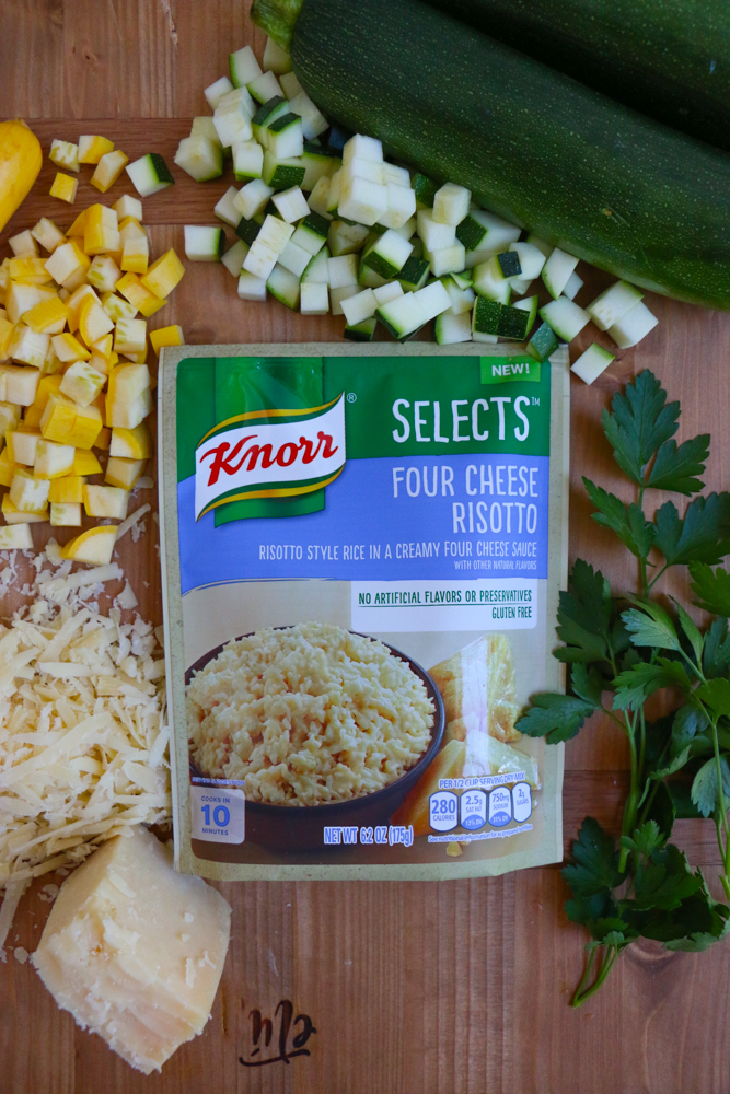 Chopped vegetables, cheese, herbs, and a package of risotto for four cheese risotto.