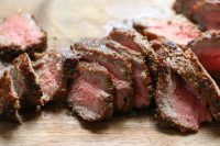 slices of medium rare steak marinated with homemade steak marinade