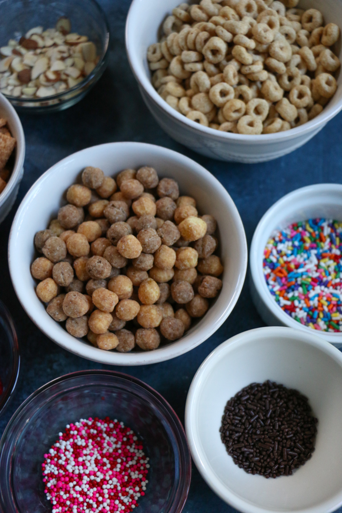 Cereal Apple Donuts! Fresh apple slices topped with peanut butter and almond butter and some of our favorite cereals from General Mills! The perfect summer snack!