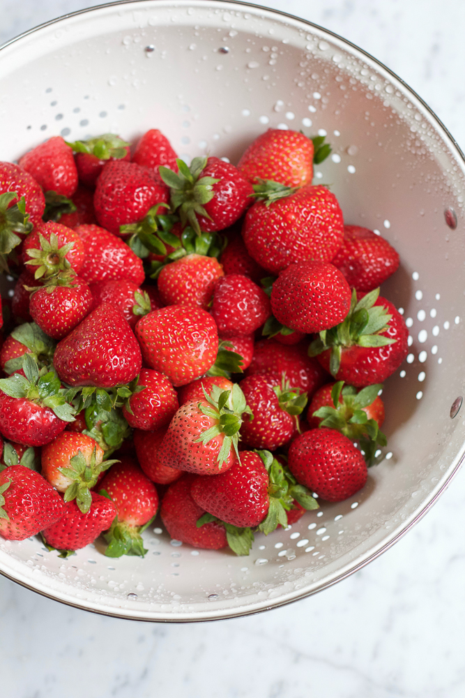 A colander of strawberries for Strawberry Galette.