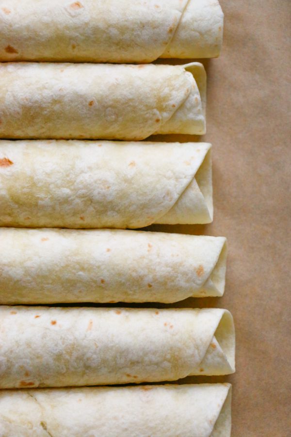 Chicken Veggie Taquitos + A Giveaway! BBQ baked shredded chicken and sauteed vegetables, rolled up into crispy, delicious BAKED taquitos! Great for packing into school lunches!