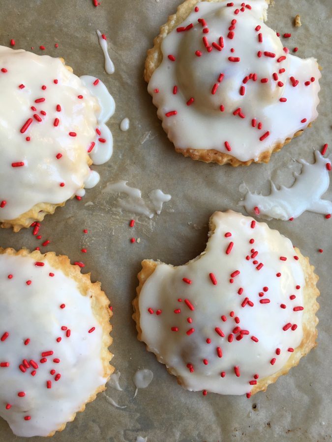 Raspberry Pop Tarts! Make your kids' favorite right at home! Made with an easy pie dough and delicious cream cheese glaze, your family is going to love these!
