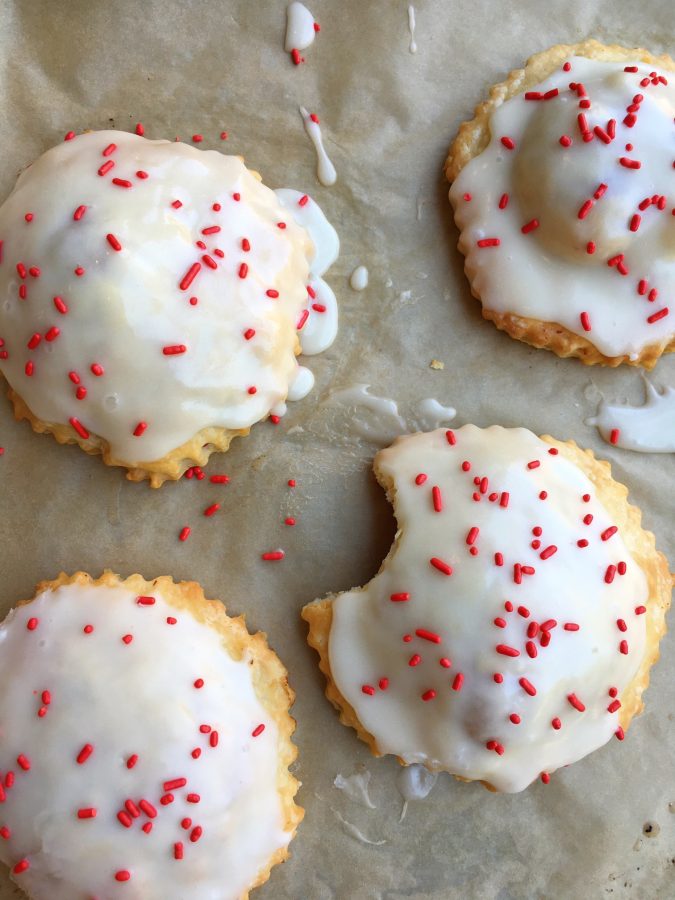 Raspberry Pop Tarts! Make your kids' favorite right at home! Made with an easy pie dough and delicious cream cheese glaze, your family is going to love these!