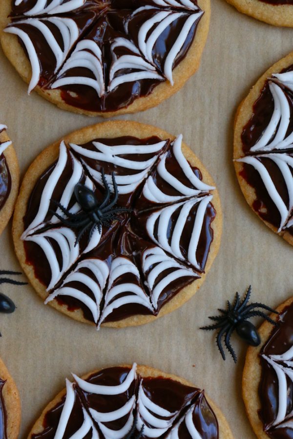Spider Web Sugar Cookies made with whole wheat flour! These cookies have a silky and smooth chocolate ganache and white icing! Perfect for a Halloween party!