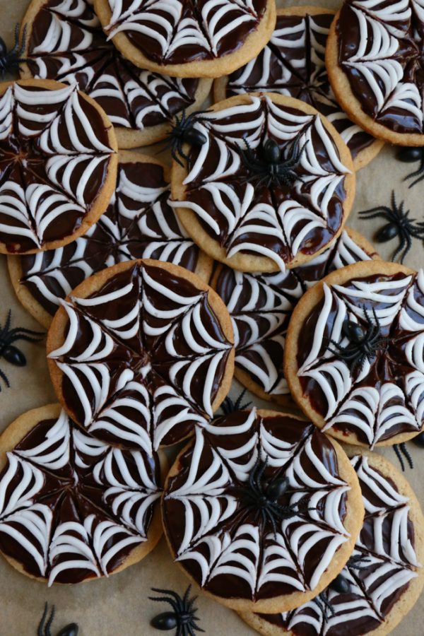 Spider Web Sugar Cookies made with whole wheat flour! These cookies have a silky and smooth chocolate ganache and white icing! Perfect for a Halloween party!