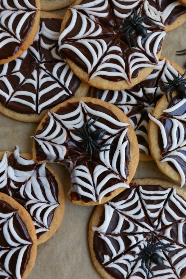 Spider Web Sugar Cookies made with whole wheat flour! These cookies have a silky and smooth chocolate ganache and white icing! Perfect for a Halloween party!