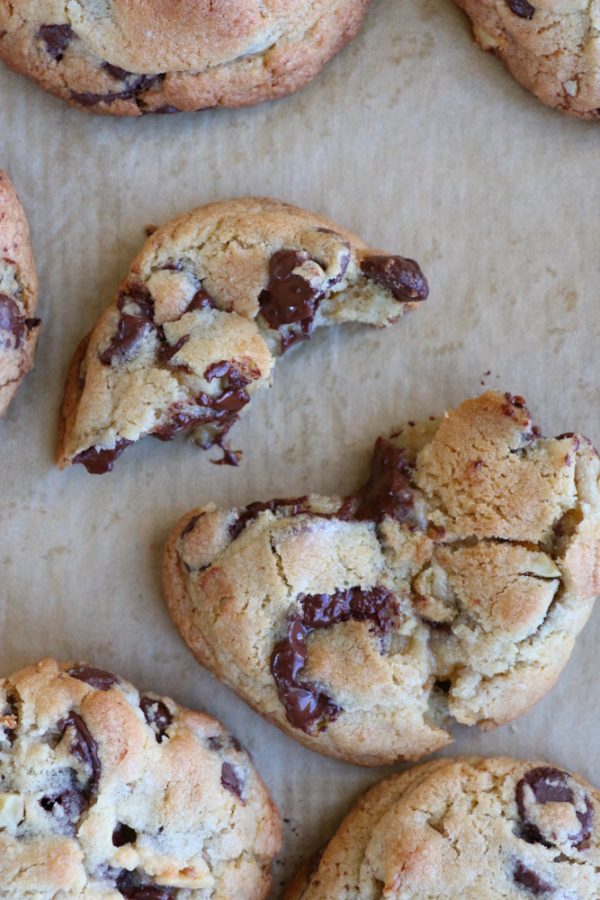 Levain Bakery cookies broken apart on parchment paper.