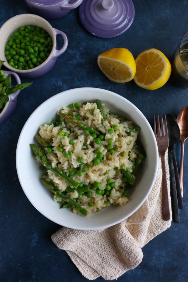 Spring Risotto with Asparagus and Peas! Spring is here! Celebrate the flavors and produce of spring by making this delicious and fabulous spring risotto! Asparagus, peas and hints of lemon, this risotto is amazing!