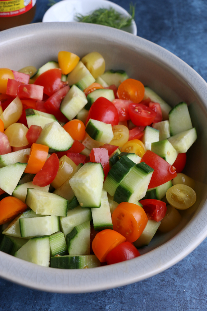 Cucumbers and tomatoes in a bowl for Super Simple Cucumber Tomato Salad.