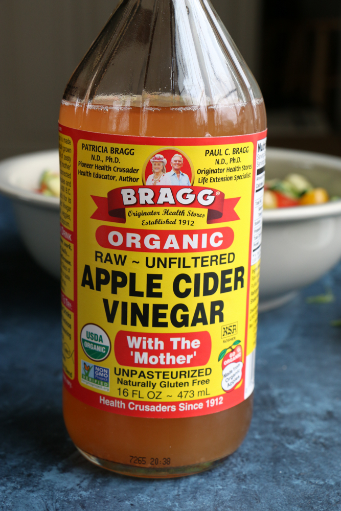 Bottle of apple cider vinegar for Super Simple Cucumber Tomato Salad.