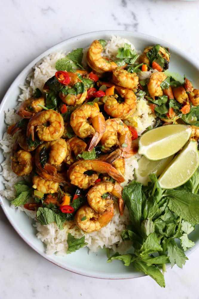 Coconut Shrimp Curry served over jasmine rice. Flavorful, delicious and with just the right amount of heat. You can also use this for chicken or veggies! You are going to love this!