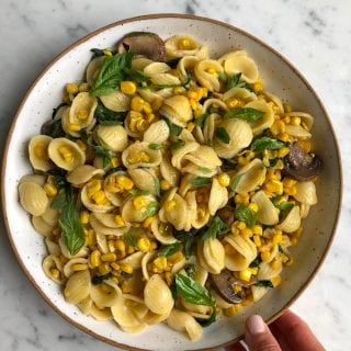 Orecchiette With Corn and Spinach!! Whether you are using up your last sweet summer corn or using frozen corn, this simple, easy and absolutely delicious pasta comes together in no time at all! 