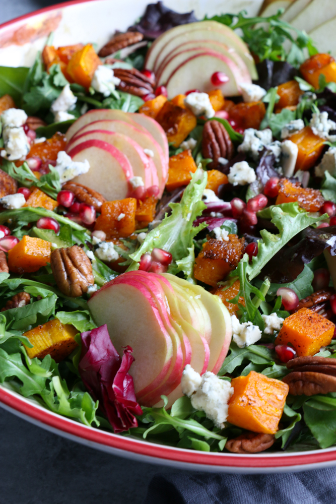 Autumn Salad with Seasoned Roasted Butternut Squash! Fresh mixed greens and arugula, apples, pears, toasted pecans and the seasoned roasted butternut squash, this is fall in a salad! You need this salad on your Thanksgiving Day table!