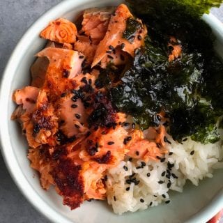 Asian Salmon Rice Bowl! Seasoned lemon pepper baked salmon served over rice with a hint of sesame oil and served with nori.